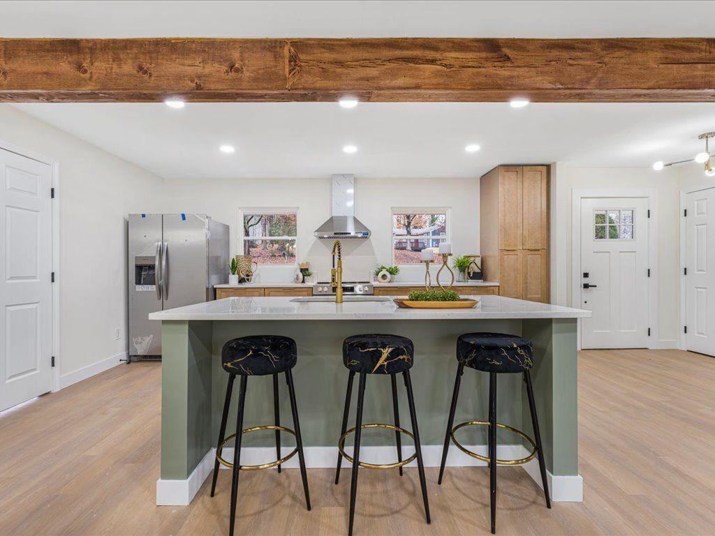 2874 Cocklebur Cove Court Decatur, GA 30034 - Photo 18 of 36 a kitchen with stainless steel appliances kitchen island granite countertop wooden floor and view living room