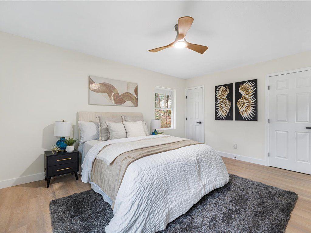 2874 Cocklebur Cove Court Decatur, GA 30034 - Photo 21 of 36 a spacious bedroom with a bed and a painting on the wall