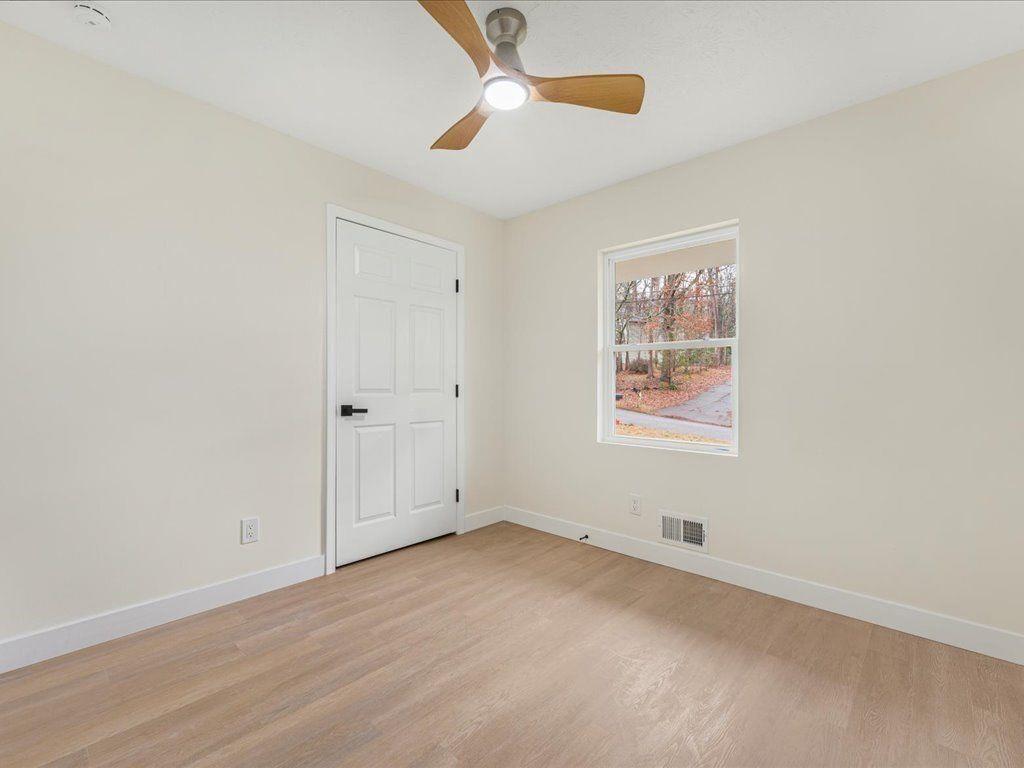 2874 Cocklebur Cove Court Decatur, GA 30034 - Photo 26 of 36 an empty room with windows and fan