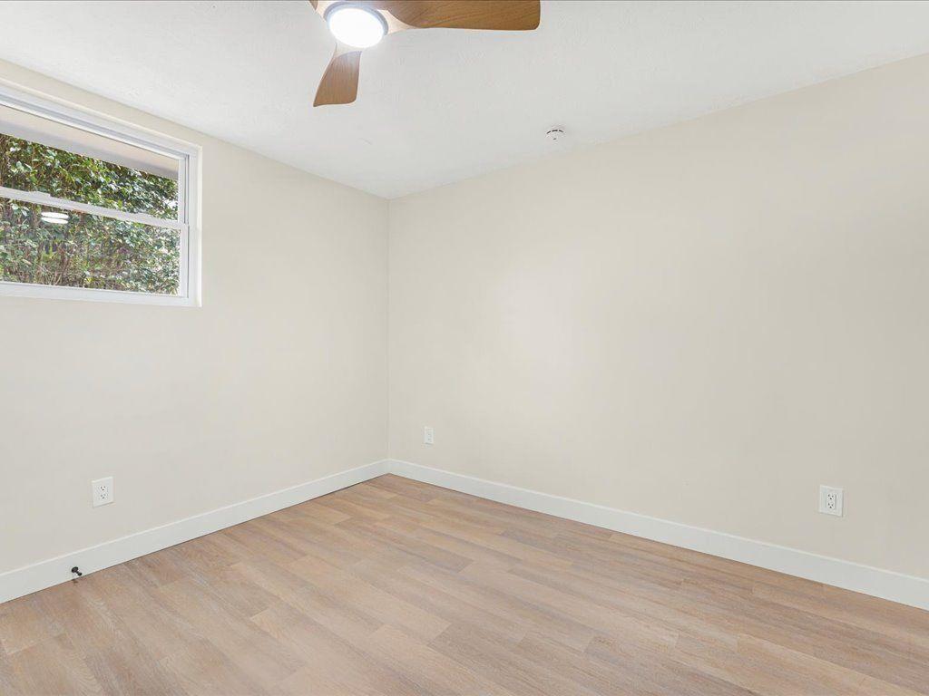 2874 Cocklebur Cove Court Decatur, GA 30034 - Photo 30 of 36 an empty room with wooden floor and windows
