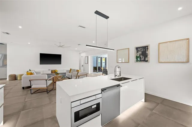 a view of living room with granite countertop furniture and a flat screen tv