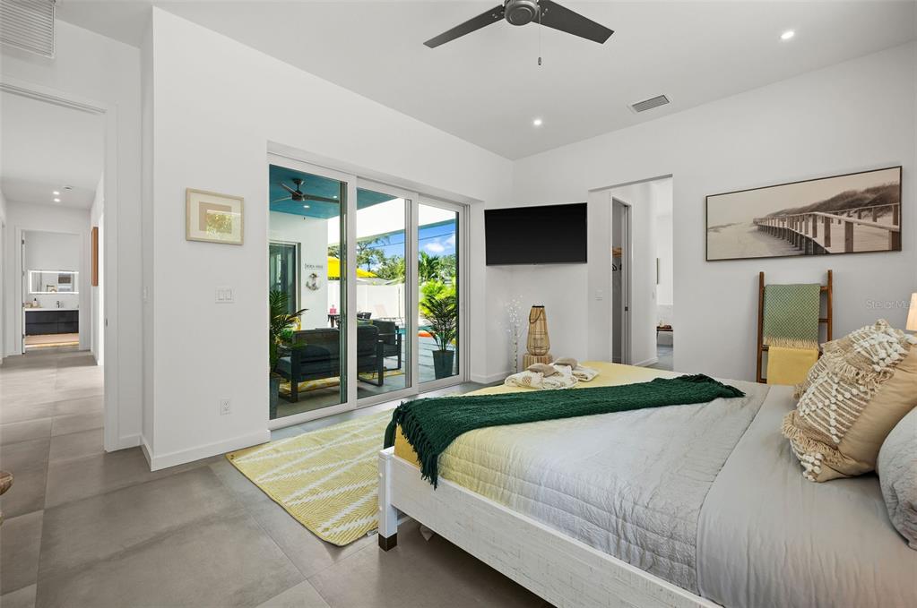 2375 Waldemere Street Sarasota, FL 34239 - Photo 16 of 36 a bedroom with a large bed and a flat screen tv