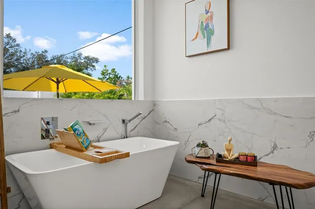 a living room with a table and a chair