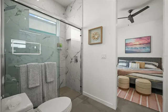 a bathroom with a toilet sink and shower