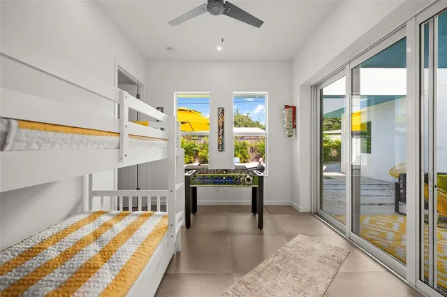 a living room with stainless steel appliances furniture and a large window