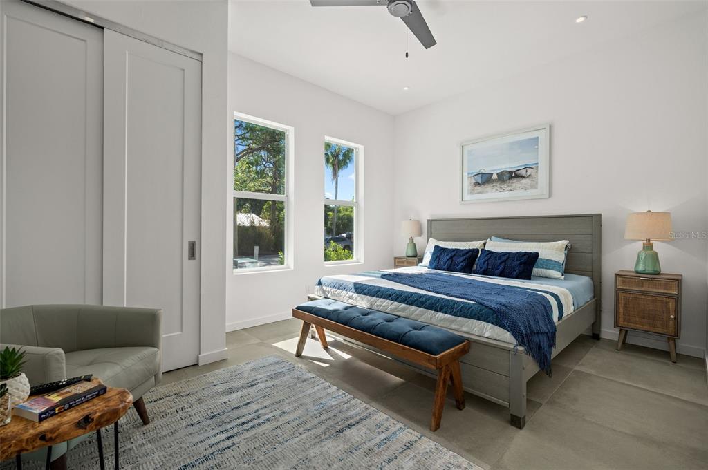 2375 Waldemere Street Sarasota, FL 34239 - Photo 27 of 36 a spacious bedroom with a bed and wooden floor