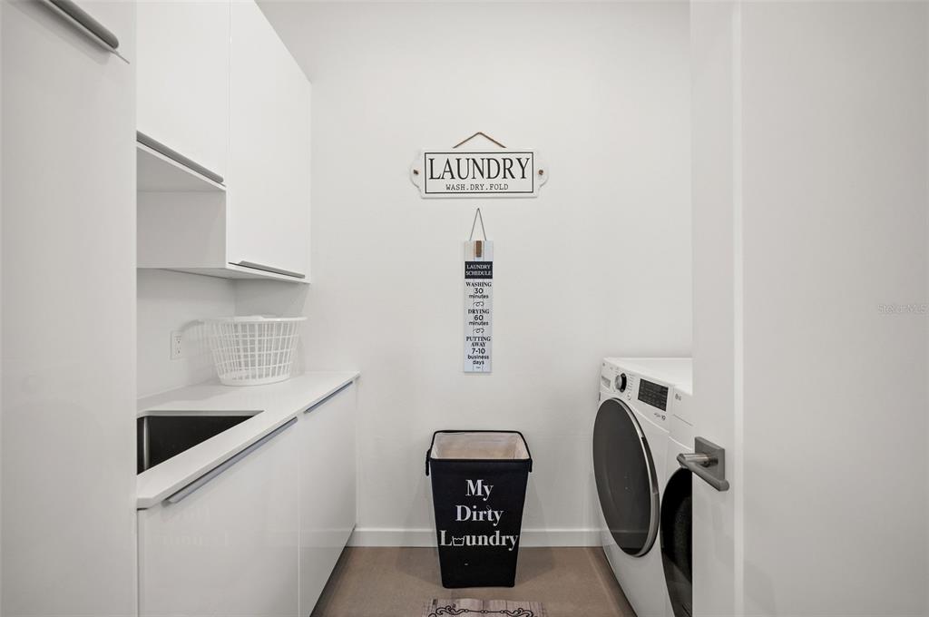 2375 Waldemere Street Sarasota, FL 34239 - Photo 29 of 36 a view of walk in closet with clothes and shoes