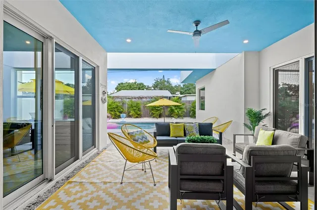 a dining room with furniture a lamp and a floor to ceiling window
