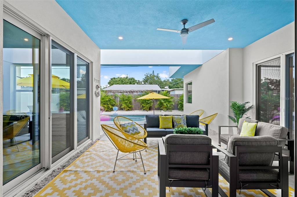 2375 Waldemere Street Sarasota, FL 34239 - Photo 31 of 36 a dining room with furniture a lamp and a floor to ceiling window