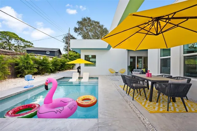 an outdoor space with furniture and umbrella