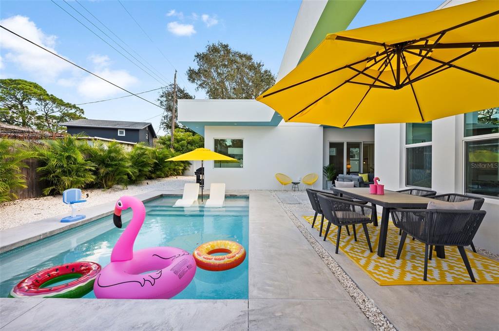 2375 Waldemere Street Sarasota, FL 34239 - Photo 32 of 36 an outdoor space with furniture and umbrella