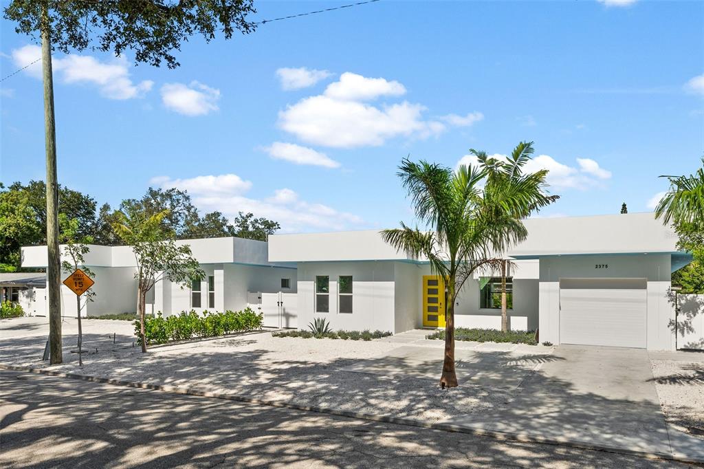 2375 Waldemere Street Sarasota, FL 34239 - Photo 34 of 36 a front view of a house with a yard and garage
