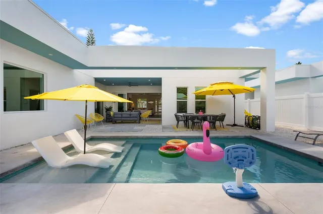a swimming pool table and chairs
