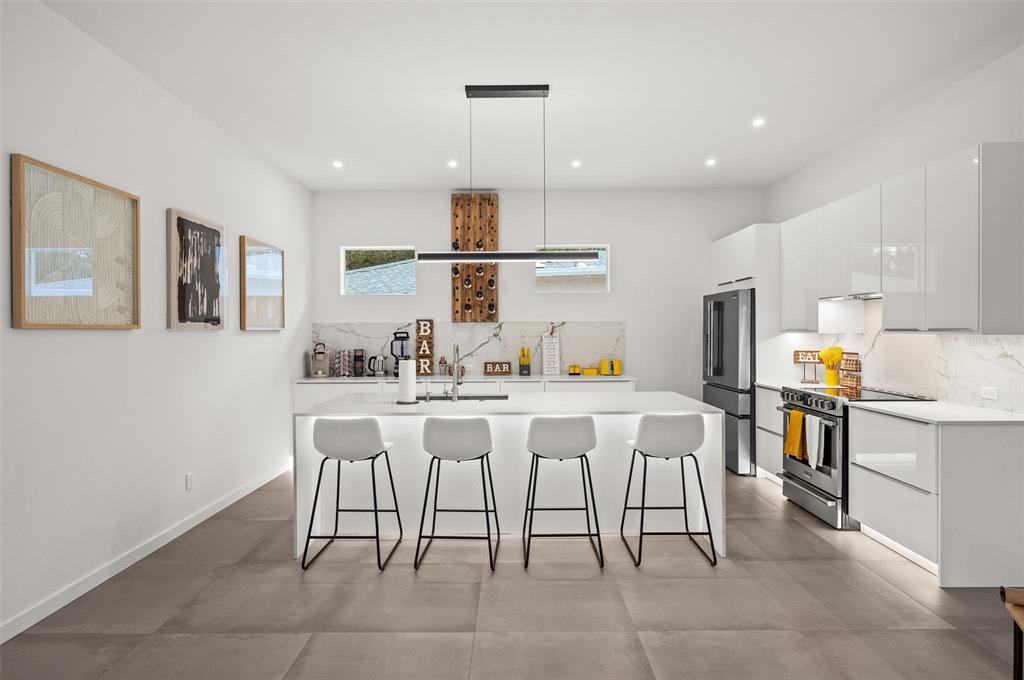 2375 Waldemere Street Sarasota, FL 34239 - Photo 10 of 36 a kitchen with a sink dining table and chairs