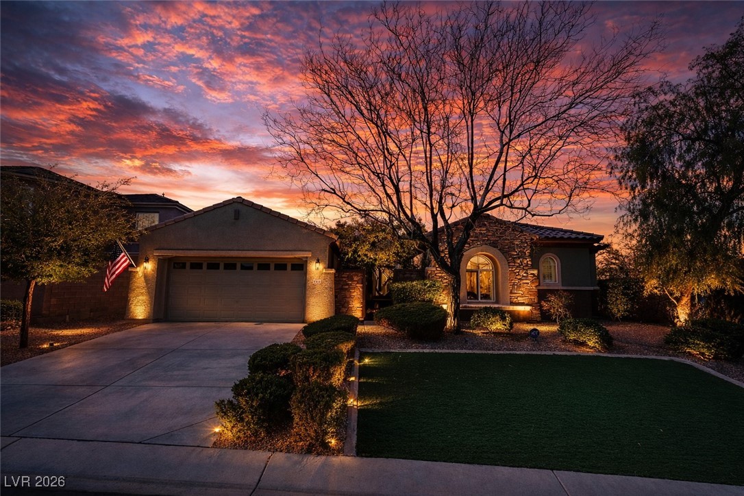 2515 Finlarig Street Henderson, NV 89044 - Photo 11 of 11 View of front of home with concrete driveway, an attached garage, stone siding, and stucco siding