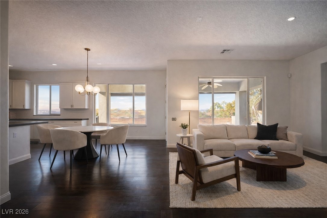 2515 Finlarig Street Henderson, NV 89044 - Photo 3 of 11 Living room with a chandelier, dark wood finished floors, recessed lighting, healthy amount of natural light, and a textured ceiling