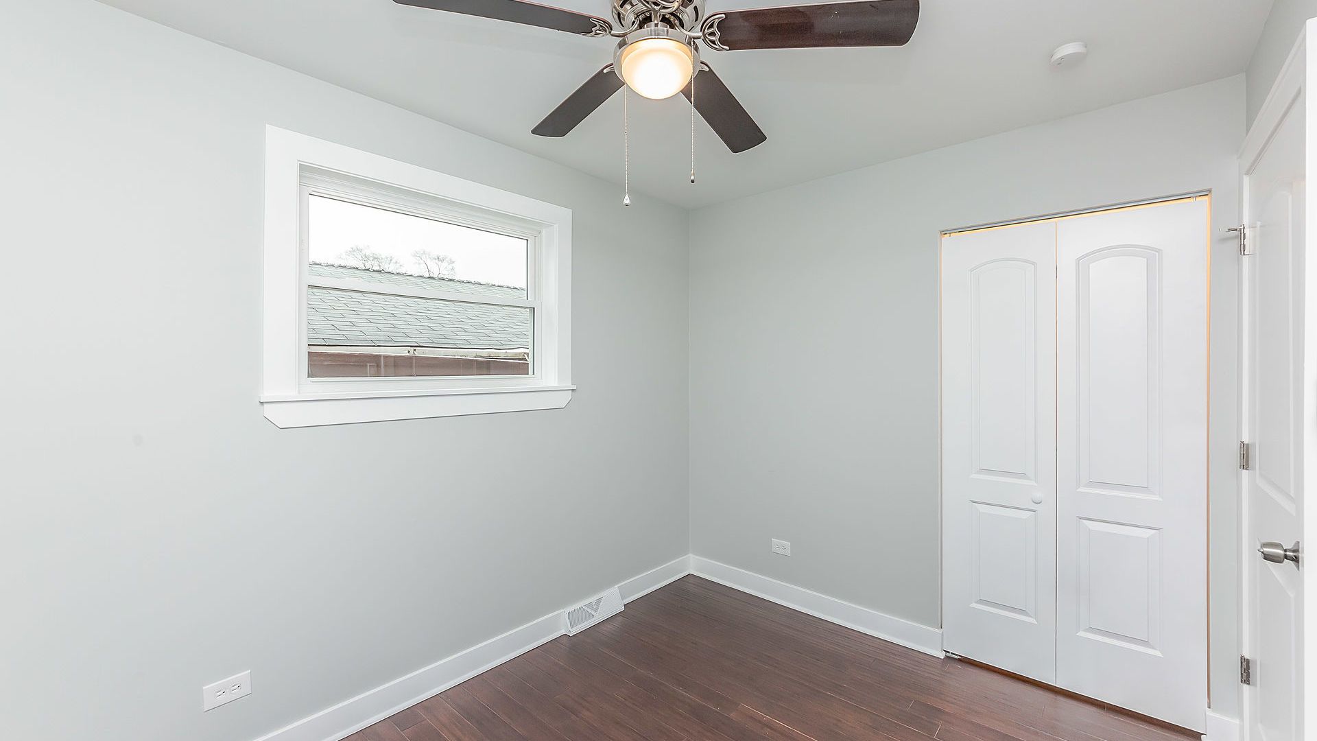 1159 West 112th Street Chicago, IL 60643 - Photo 11 of 27 an empty room with a window and wooden floor