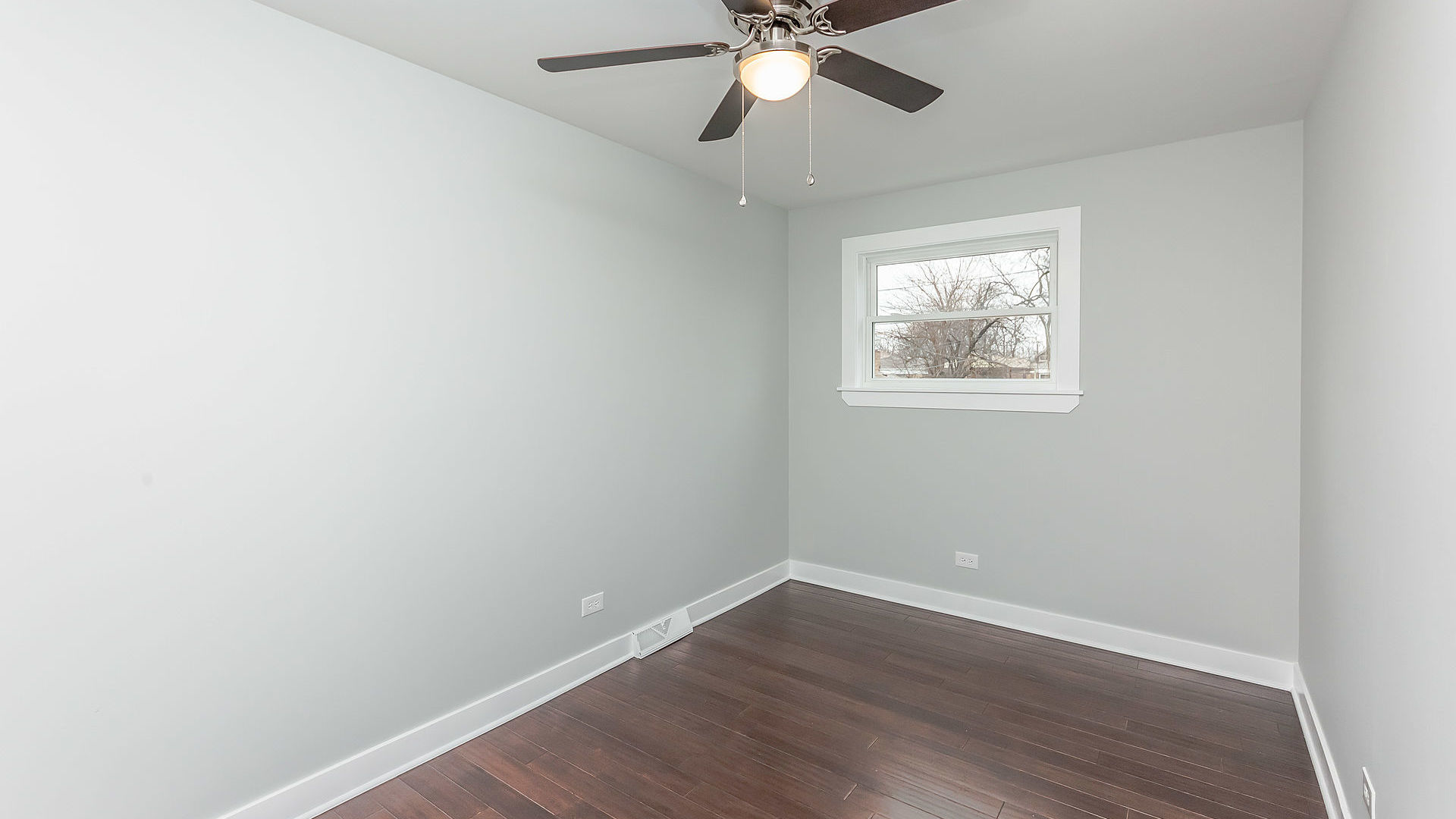 1159 West 112th Street Chicago, IL 60643 - Photo 13 of 27 an empty room with wooden floor fan and windows