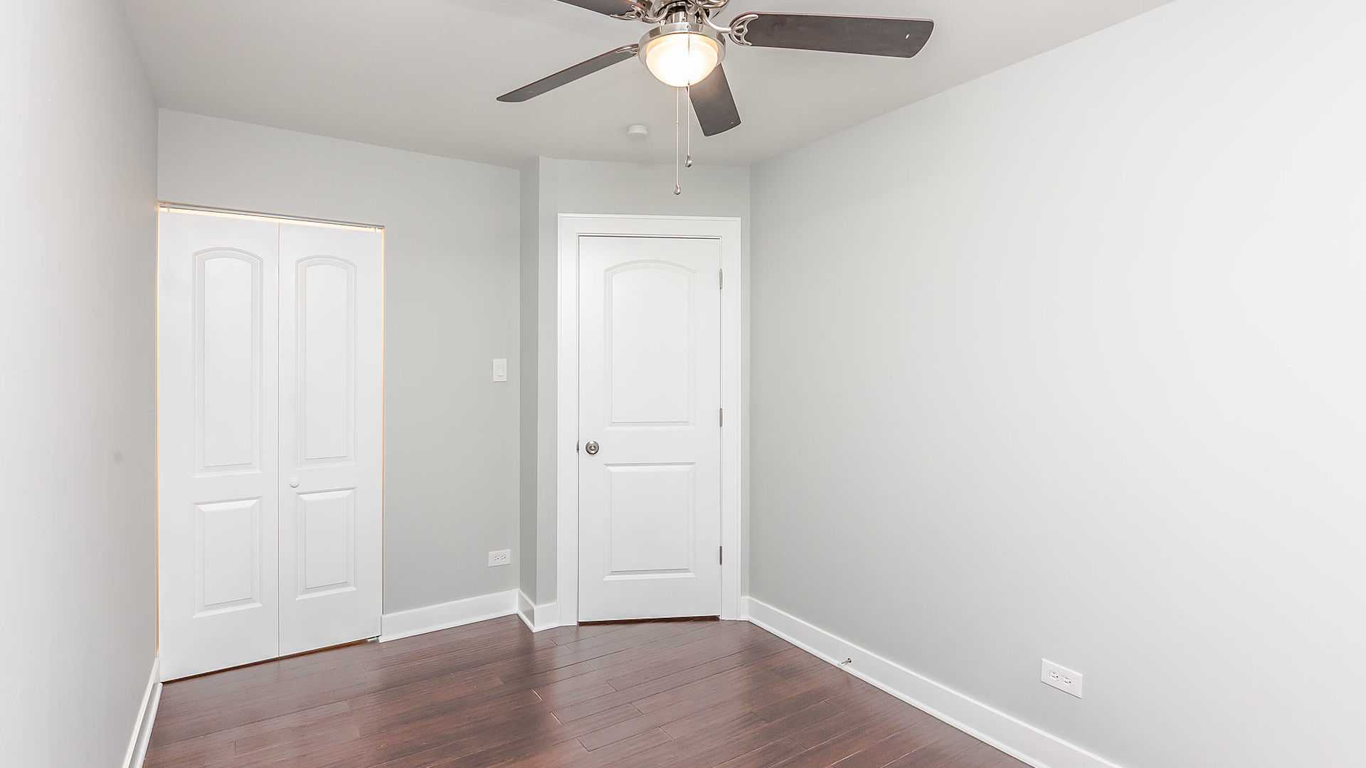 1159 West 112th Street Chicago, IL 60643 - Photo 15 of 27 an empty room with wooden floor and ceiling fan