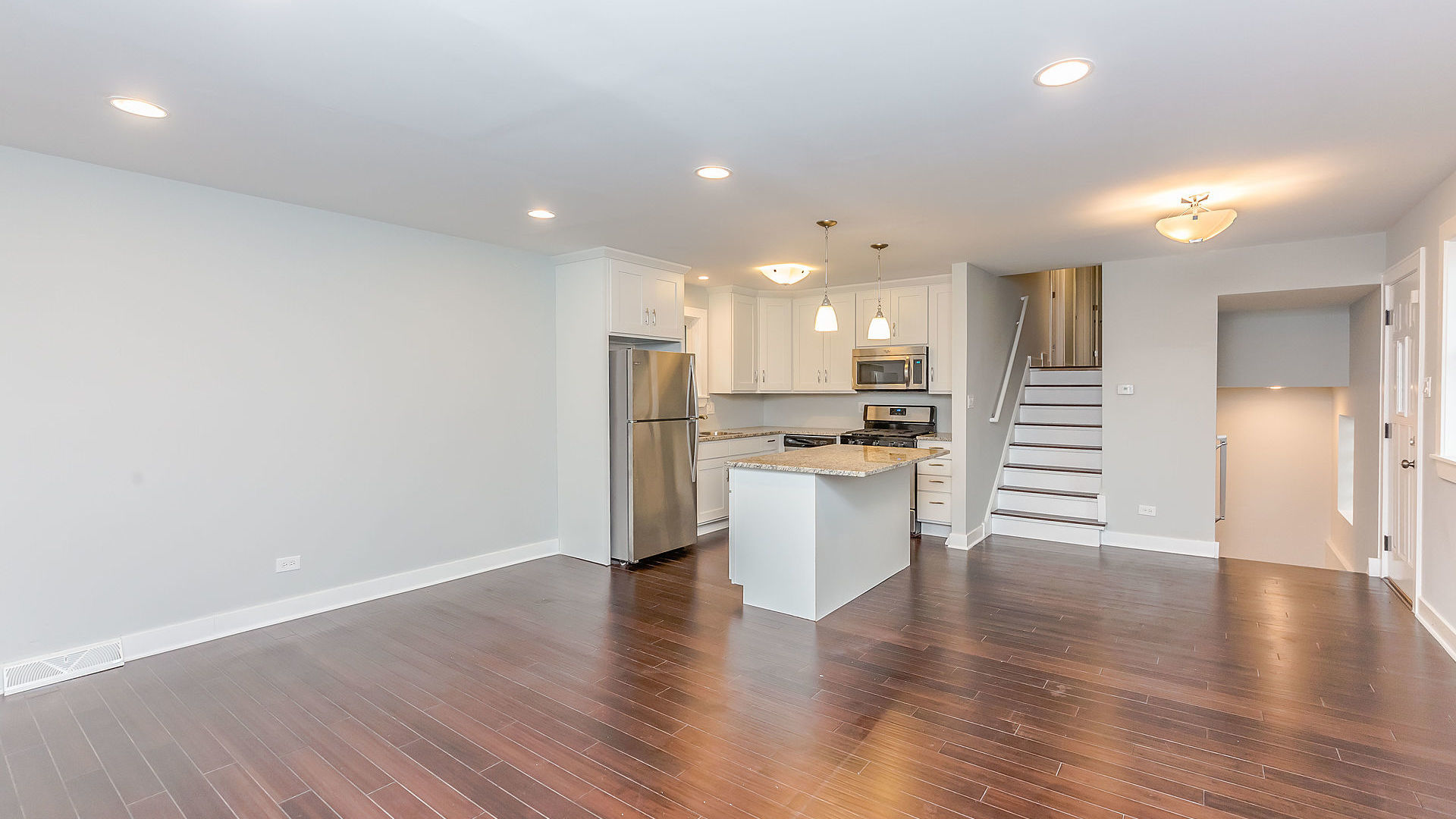 1159 West 112th Street Chicago, IL 60643 - Photo 3 of 27 a view of kitchen with stainless steel appliances refrigerator oven and white cabinets with wooden floor