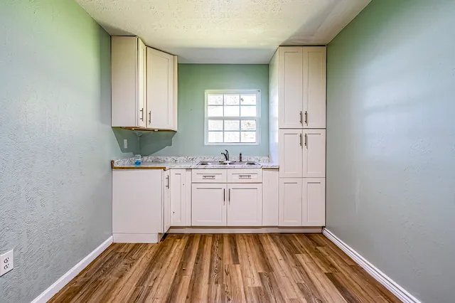 a kitchen with sink and cabinets