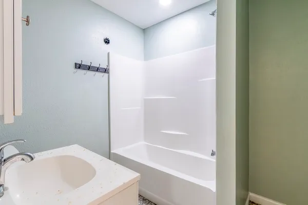 a bathroom with a bathtub and a sink