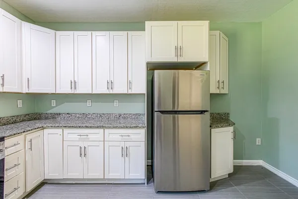 a white refrigerator freezer sitting in a kitchen