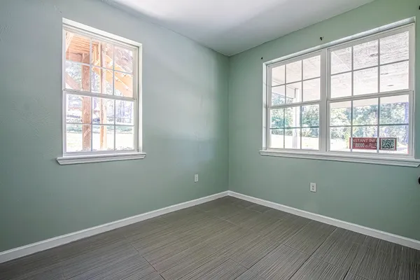 a view of a room with wooden floor and windows