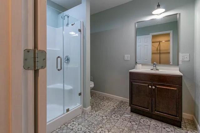 a kitchen with granite countertop stainless steel appliances a sink and cabinets