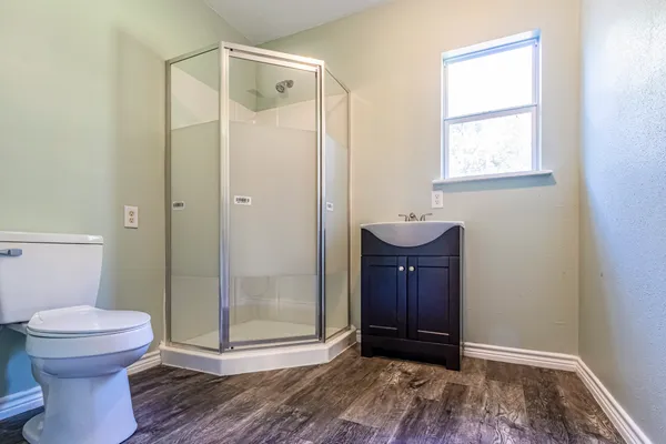 a bathroom with a toilet and a shower