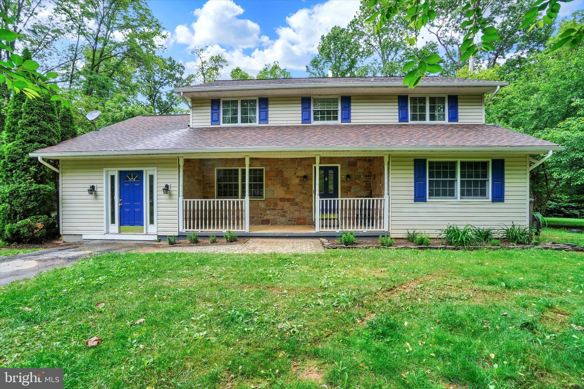 a view of a brick house with a large windows and a large tree