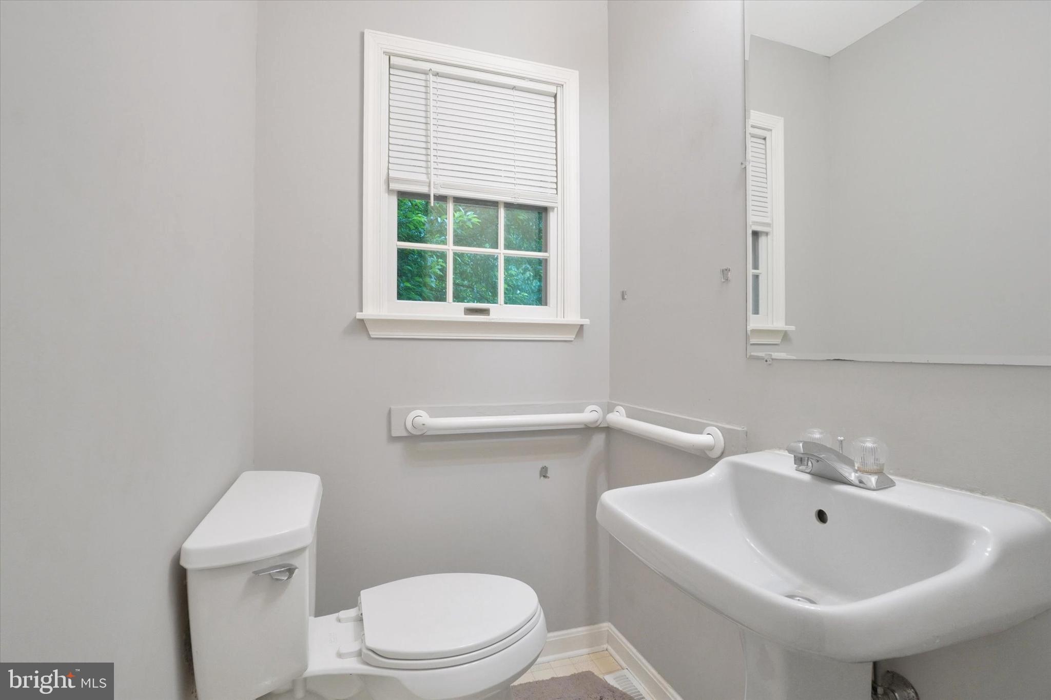 5677 Woods Road Stewartstown, PA 17363 - Photo 11 of 26 a bathroom with a sink a toilet and a mirror