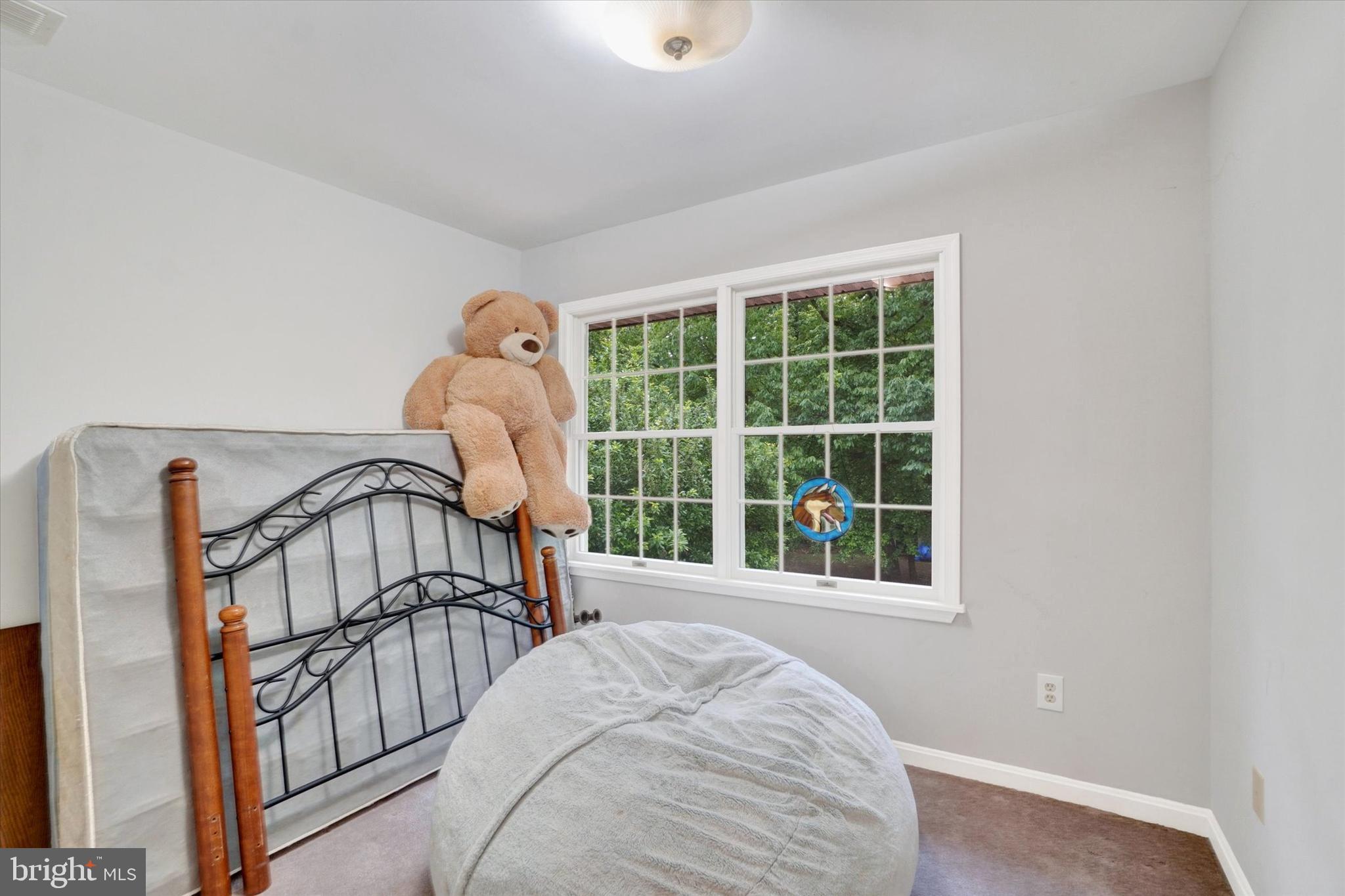 5677 Woods Road Stewartstown, PA 17363 - Photo 15 of 26 a bedroom with a bed and a large window