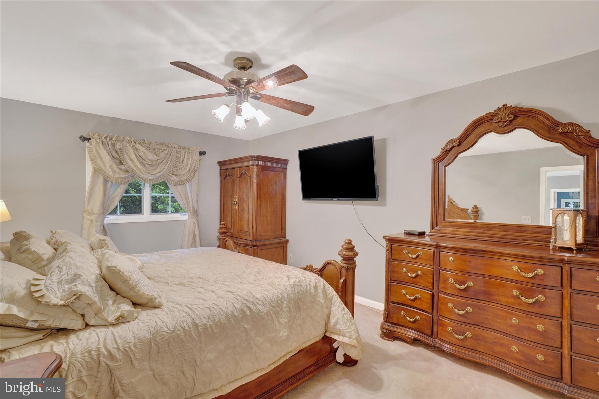 5677 Woods Road Stewartstown, PA 17363 - Photo 16 of 26 a bedroom with a large bed and a flat screen tv