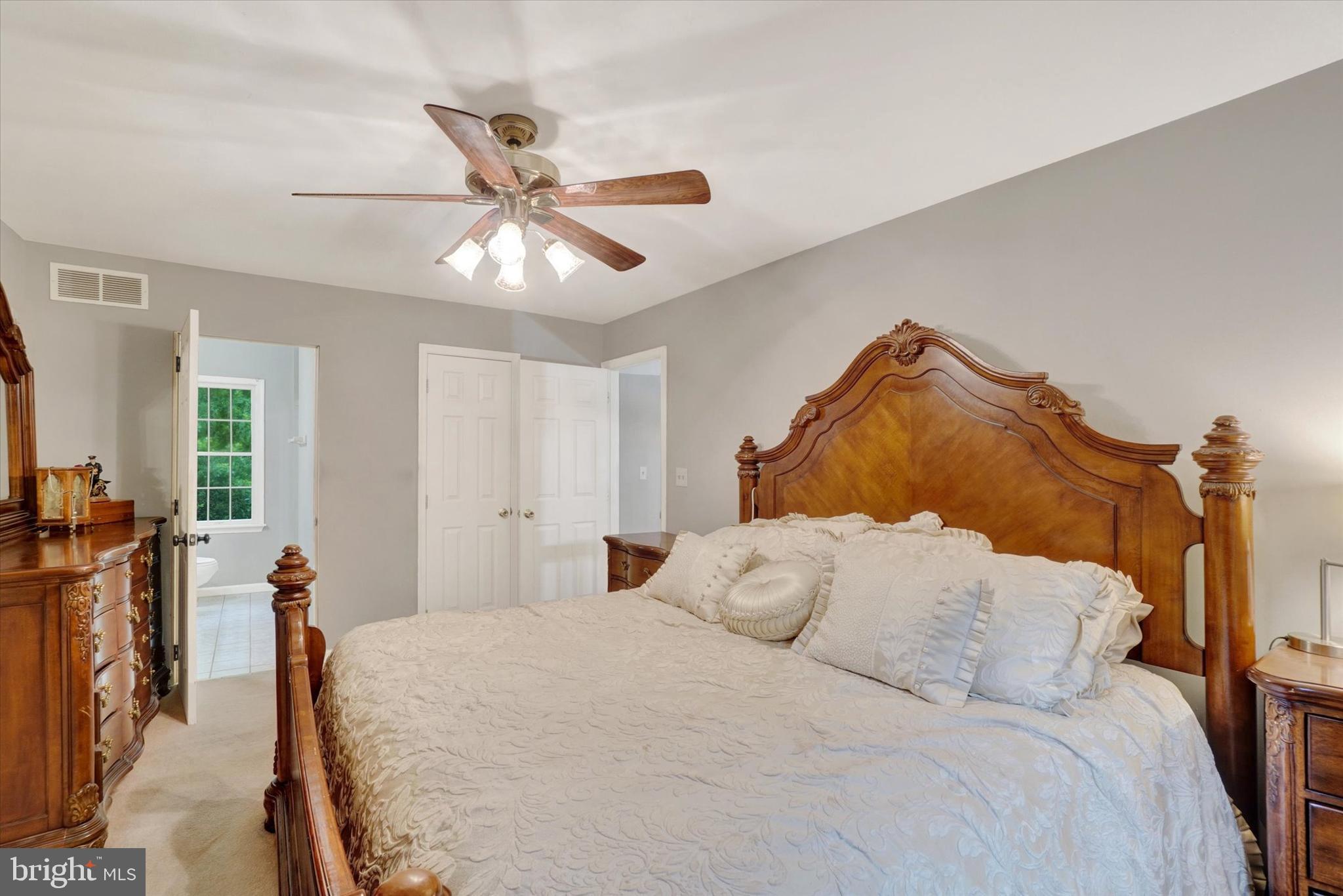 5677 Woods Road Stewartstown, PA 17363 - Photo 17 of 26 a bedroom with a bed and a chandelier