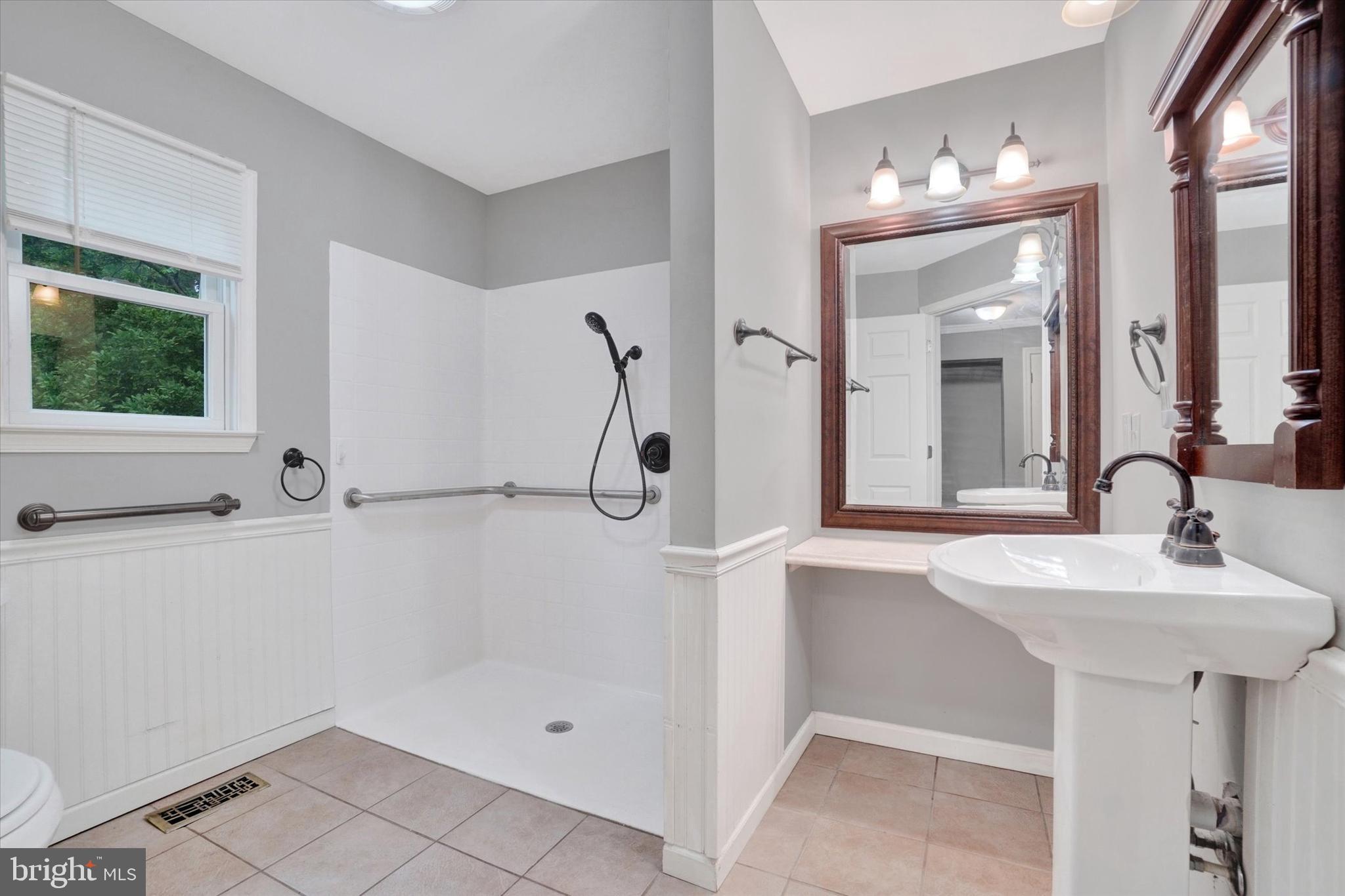 5677 Woods Road Stewartstown, PA 17363 - Photo 19 of 26 a bathroom with a sink a mirror and shower