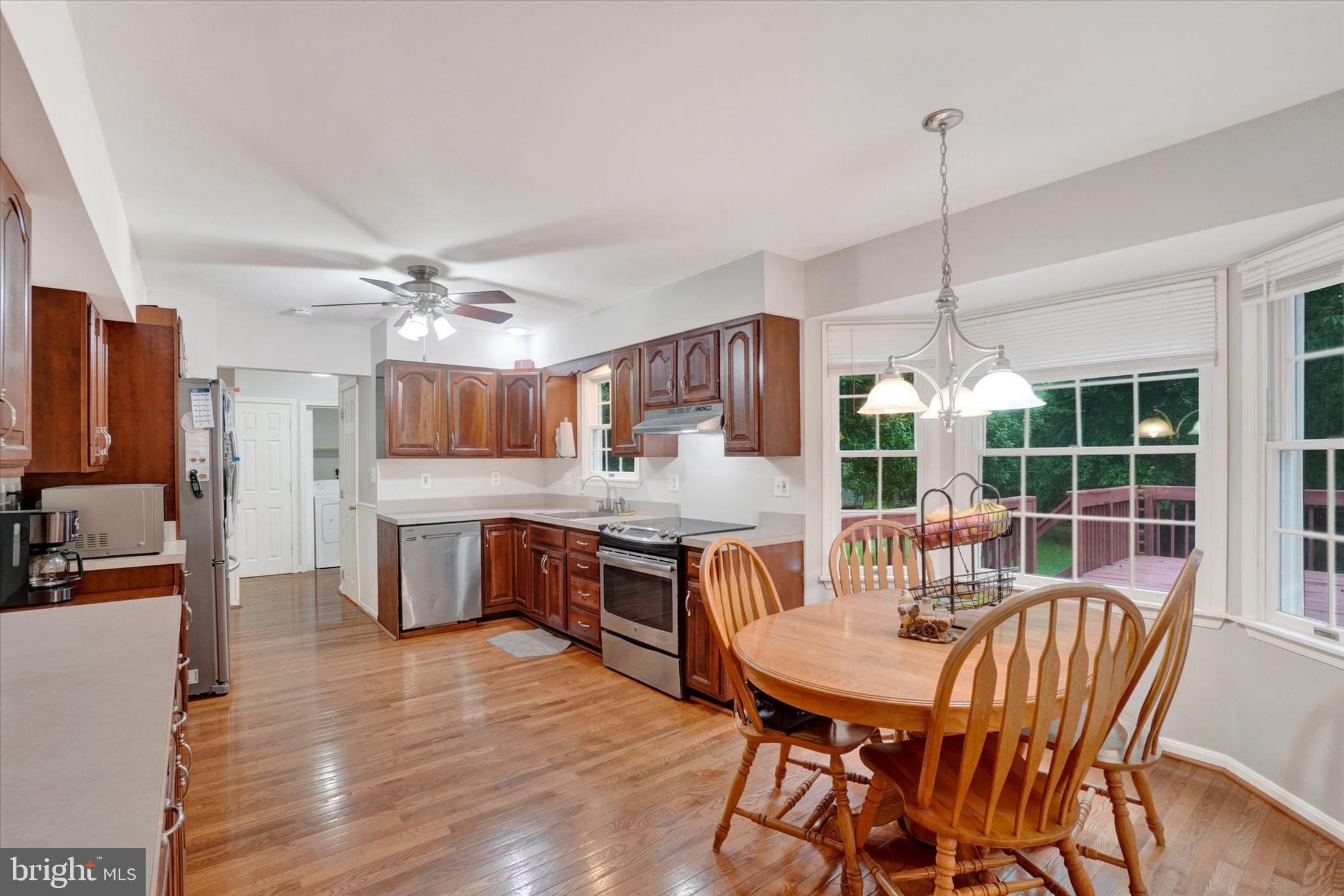 5677 Woods Road Stewartstown, PA 17363 - Photo 7 of 26 a view of a dining room with furniture window and wooden floor