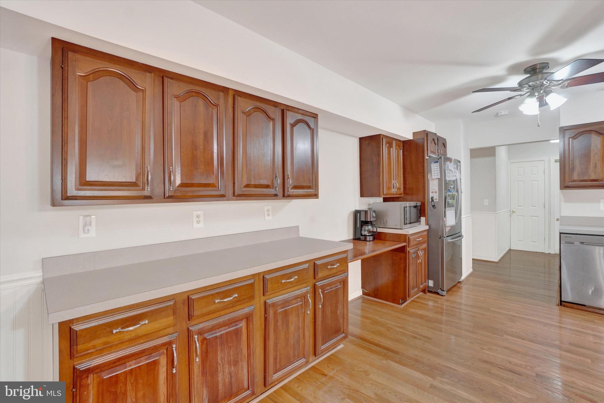 5677 Woods Road Stewartstown, PA 17363 - Photo 9 of 26 a kitchen with stainless steel appliances granite countertop a sink dishwasher stove and wooden cabinets
