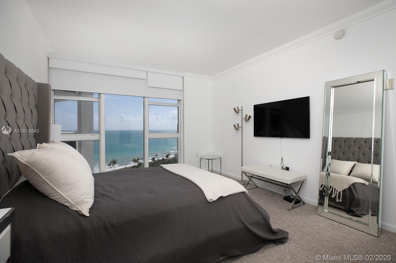 10275 Collins Avenue, Unit 1218 Bal Harbour, FL 33154 - Photo 8 of 13 a bedroom with a bed and a flat screen tv