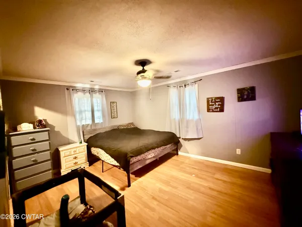 a bedroom with furniture and a chandelier