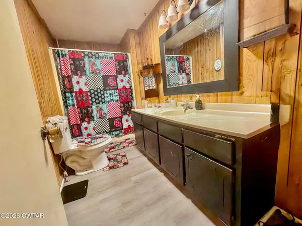 a bathroom with a sink mirror vanity and toilet