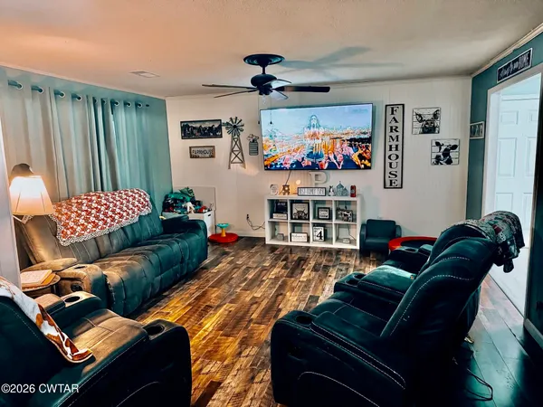 a living room with furniture and a flat screen tv