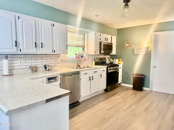 a kitchen with a sink stove and refrigerator