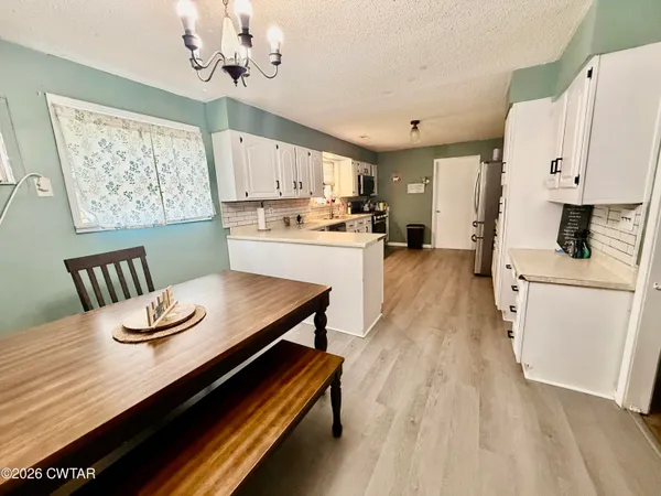 a kitchen with sink cabinets and wooden floor