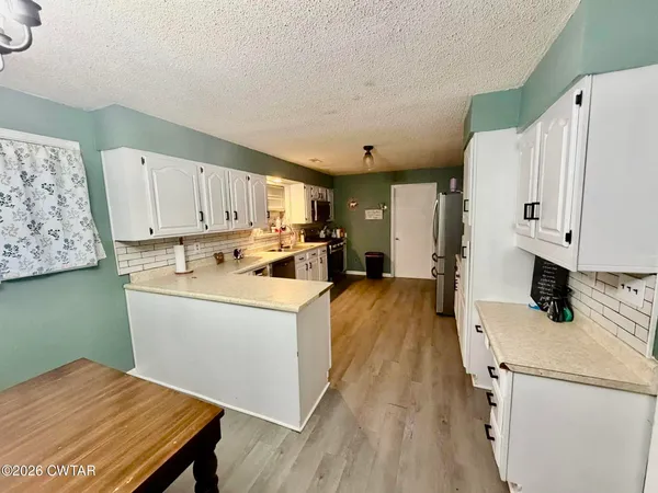 a view of kitchen and wooden floor