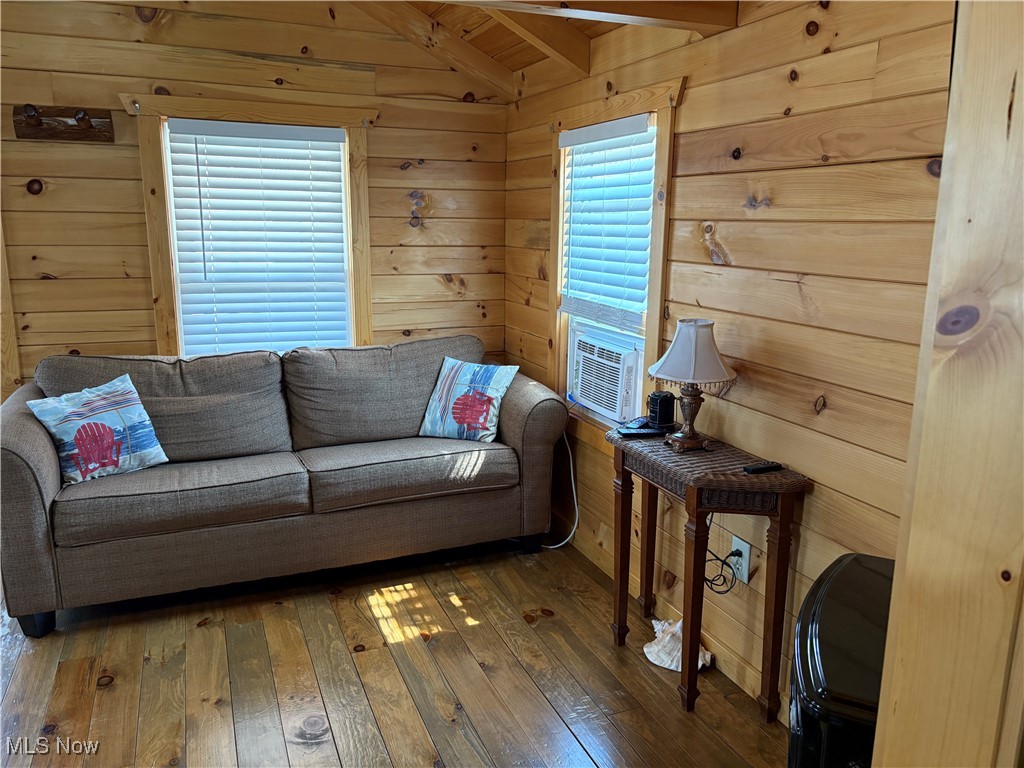 5919 Lake Road West, Unit 13 Ashtabula, OH 44004 - Photo 6 of 35 Living room featuring hardwood / wood-style flooring, wood walls, and wooden ceiling