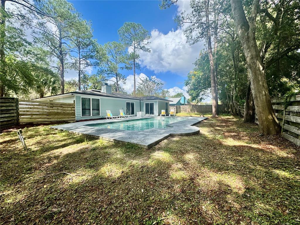 5407 Southwest 82 Terrace Gainesville, FL 32608 - Photo 27 of 31 a view of a house with swimming pool next to a yard