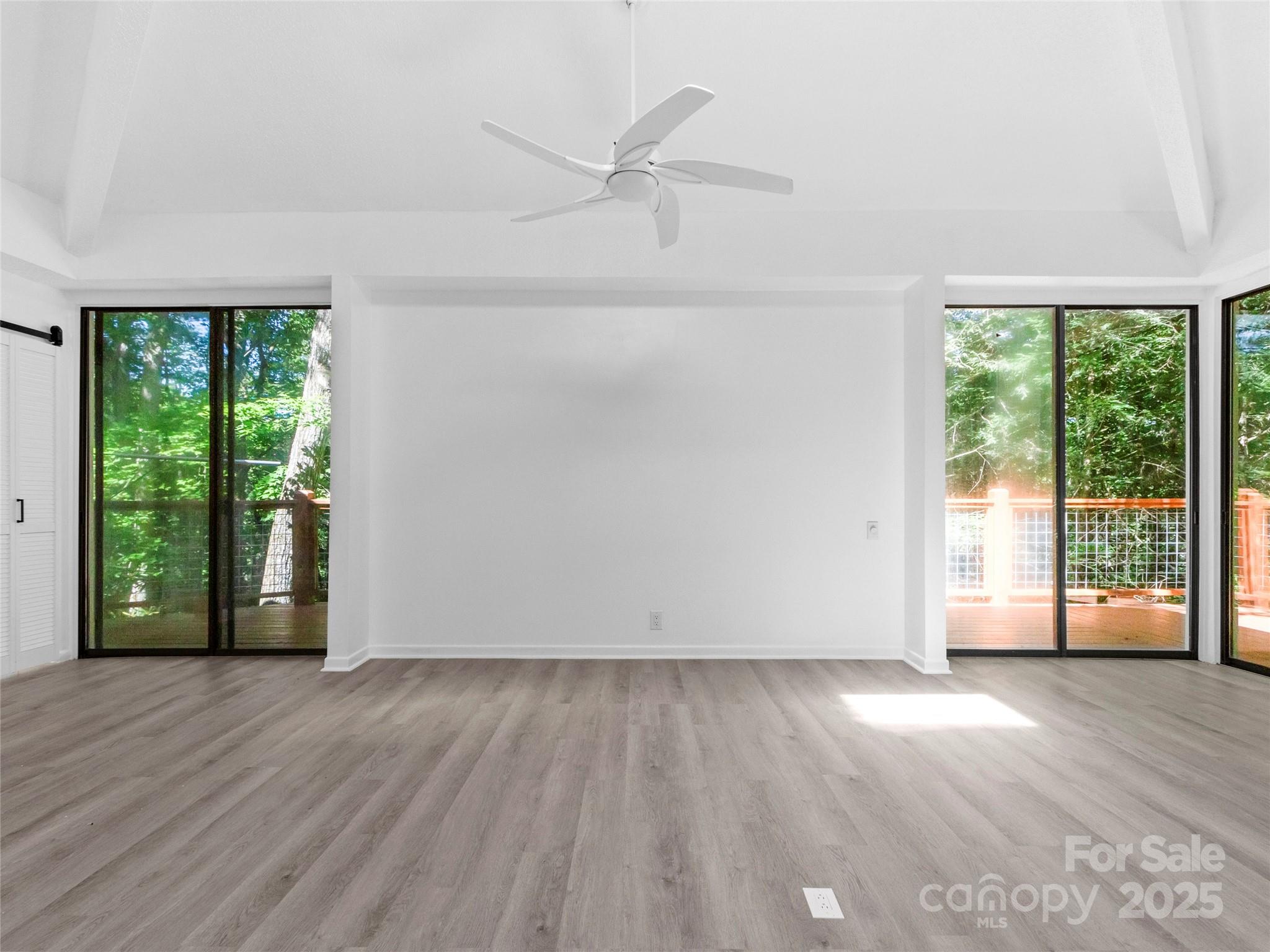 141 Wildflower Road Spruce Pine, NC 28777 - Photo 12 of 22 an empty room with wooden floor and a window
