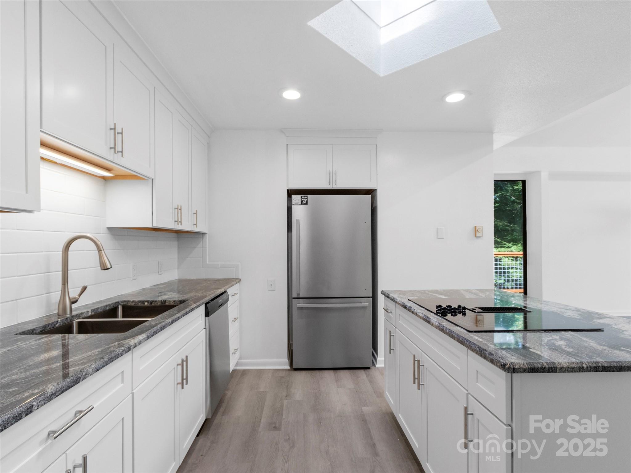 141 Wildflower Road Spruce Pine, NC 28777 - Photo 19 of 22 a kitchen with granite countertop a refrigerator and a sink
