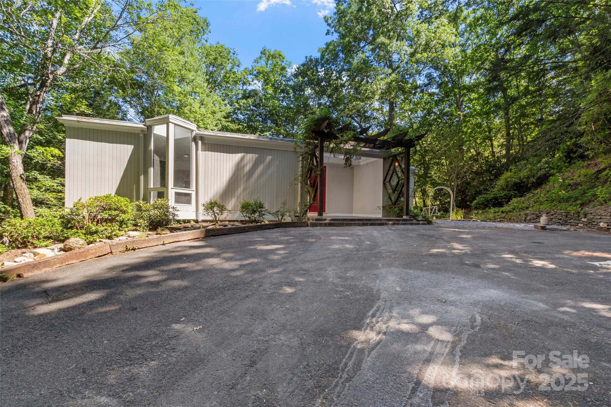 141 Wildflower Road Spruce Pine, NC 28777 - Photo 3 of 22 a front view of a house with garden